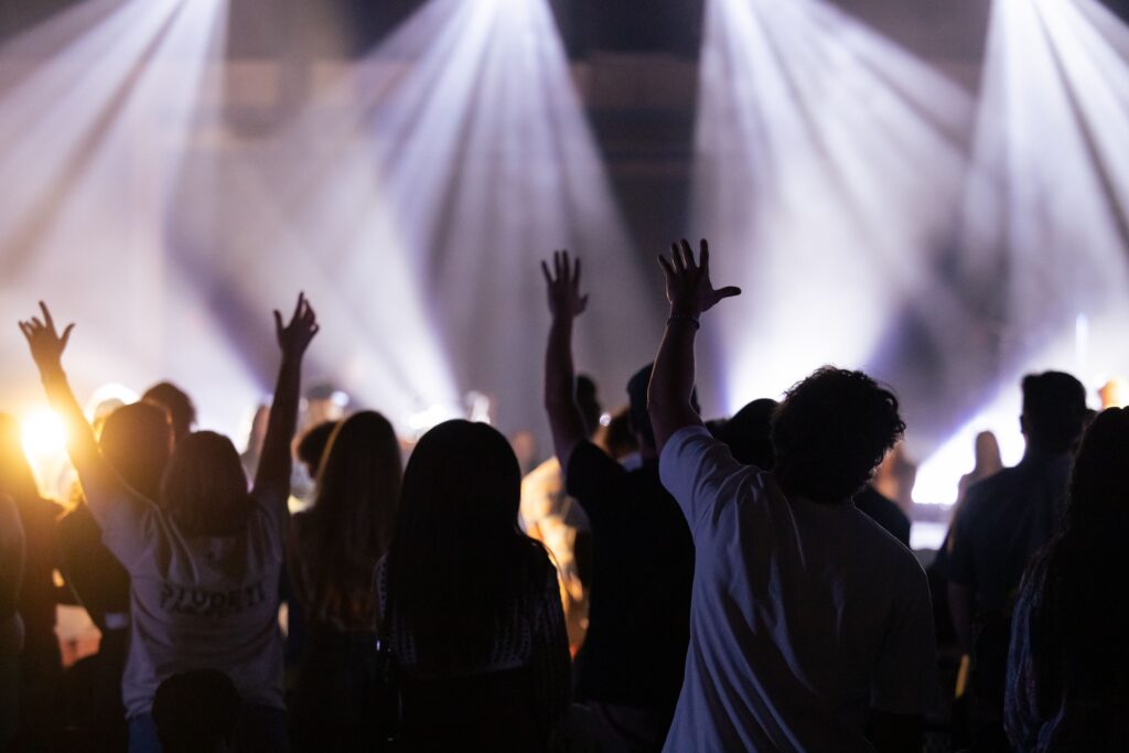 Crowd jumping up and down in the spotlights