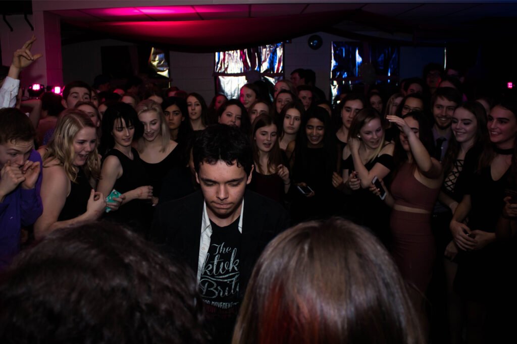 Students watch another break it down on the dance floor.