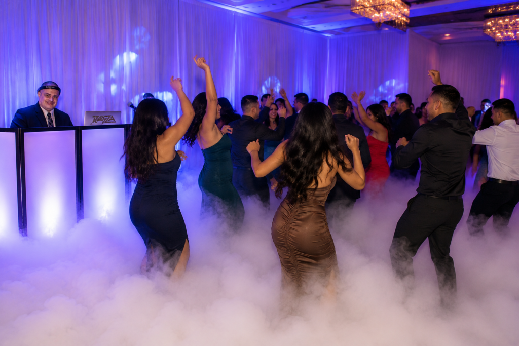 DJ Rayza performs at a an event with the Cloud Nine effect for the dancers